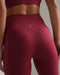 Rhone Revive 7/8 Pocket Legging in Cranberry at Baseline Social