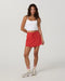 Vuori Daily Skirt in Crimson at Baseline Social